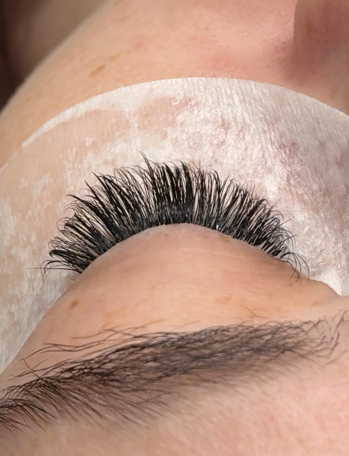 A close view of a completed eyelash extension set